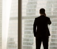 CEO standing at the window on the phone