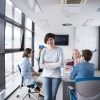 business women - app entrepreneur standing in front of table