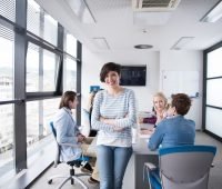 business women - app entrepreneur standing in front of table