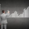startup growth strategy - man writing bar graph on chalkboard