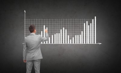 startup growth strategy - man writing bar graph on chalkboard